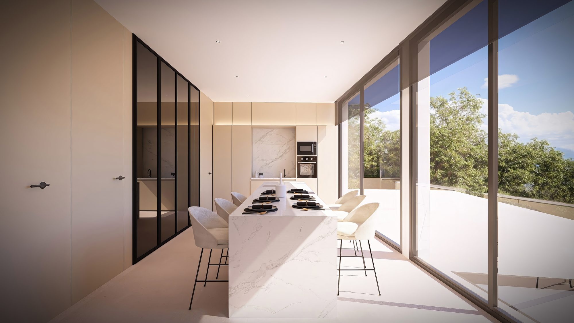 Cocina con isla de mármol abierta a la terraza en la villa de Roca Llisa
